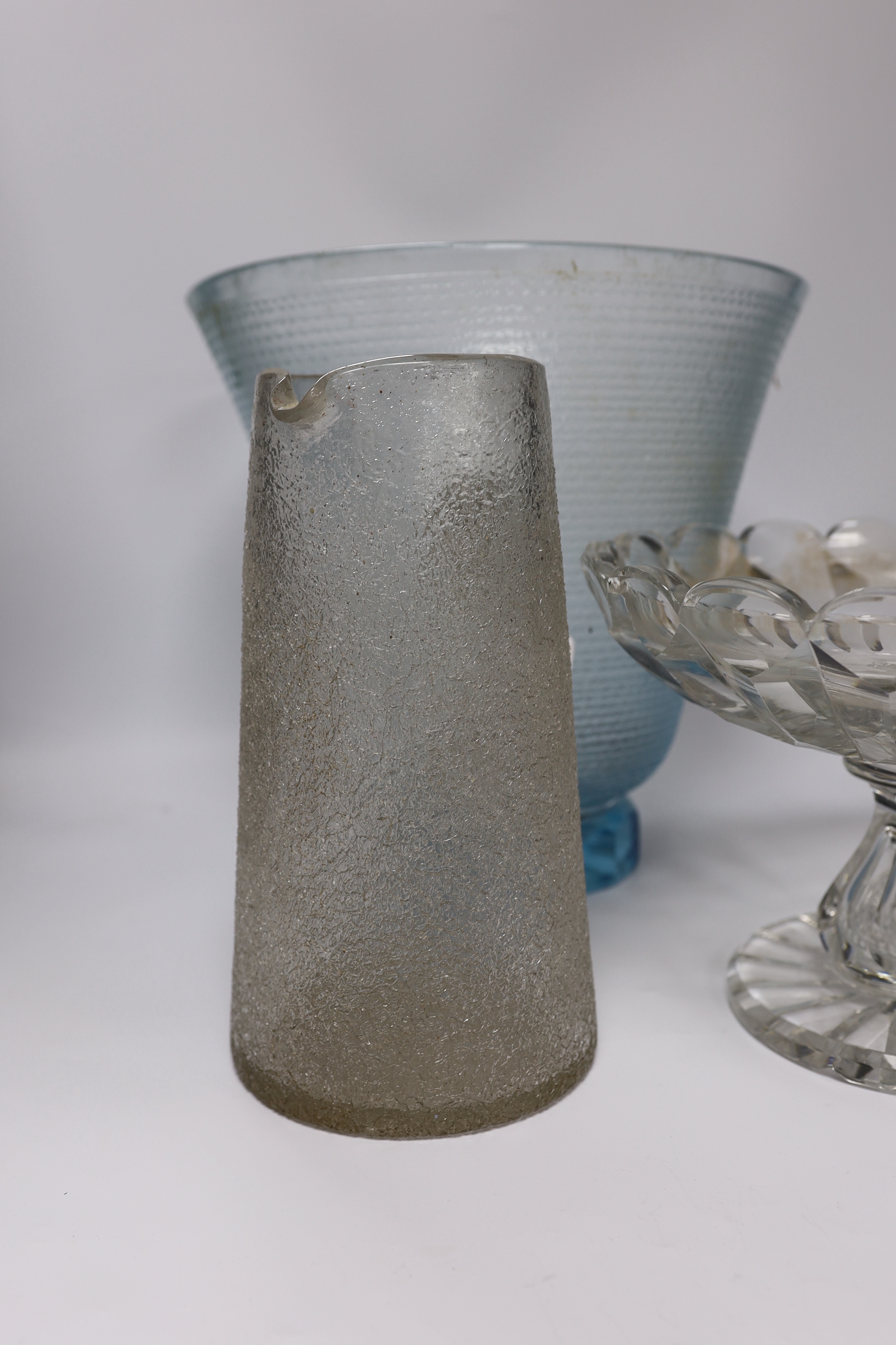 A large heavy cut glass tazza with shaped rim, a tall blue tinted textured vase, height 31.5cm and a crackle finish water jug (3)